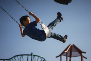 Child on a swing in the park