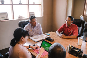 Three teachers meeting in an office